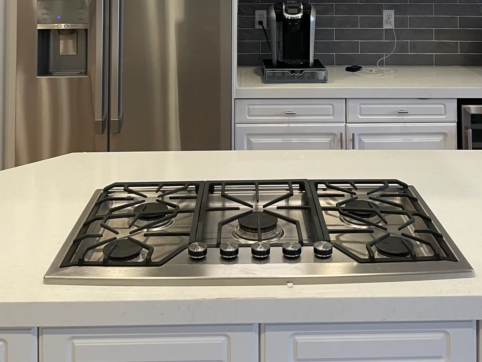 Gas cooktop installed in a white kitchen island