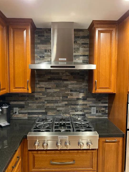 Gas range and vent hood installation photo
