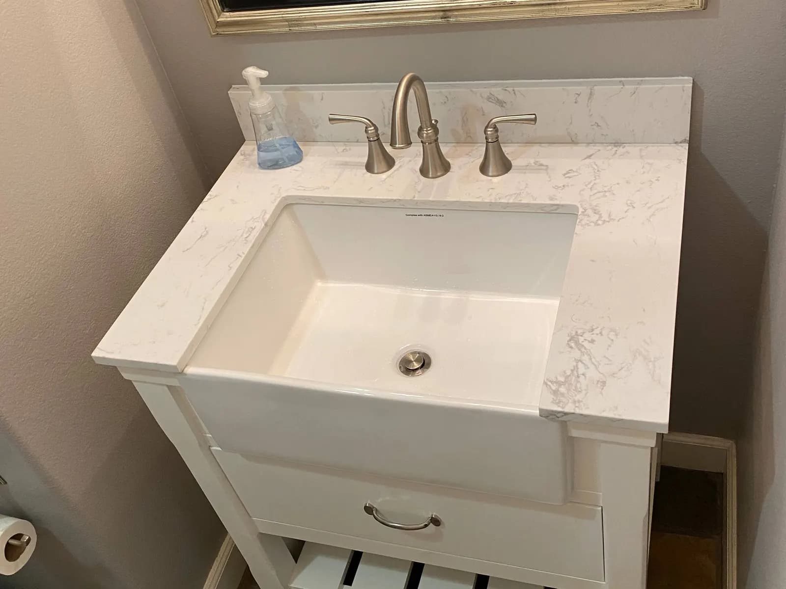 Bathroom vanity with a newly installed faucet and sink