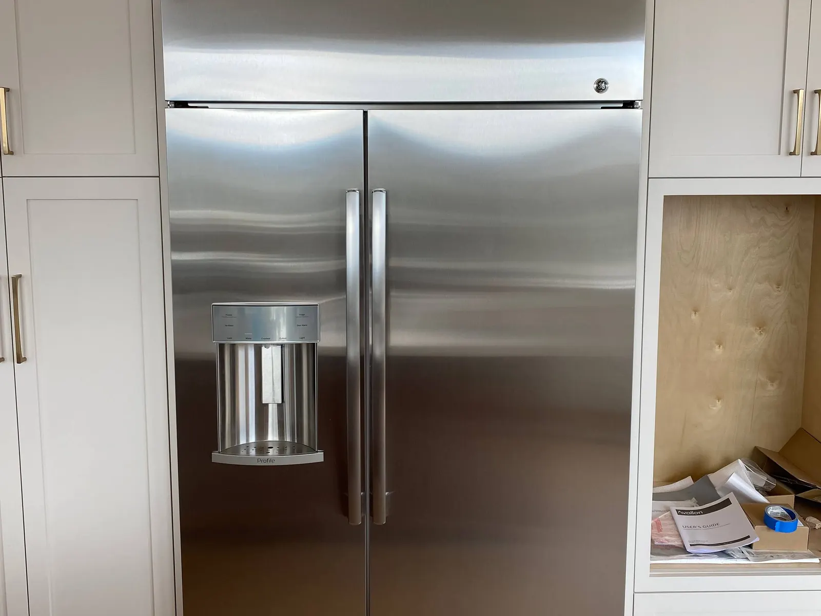 Built-in side-by-side refrigerator fitted into white cabinetry