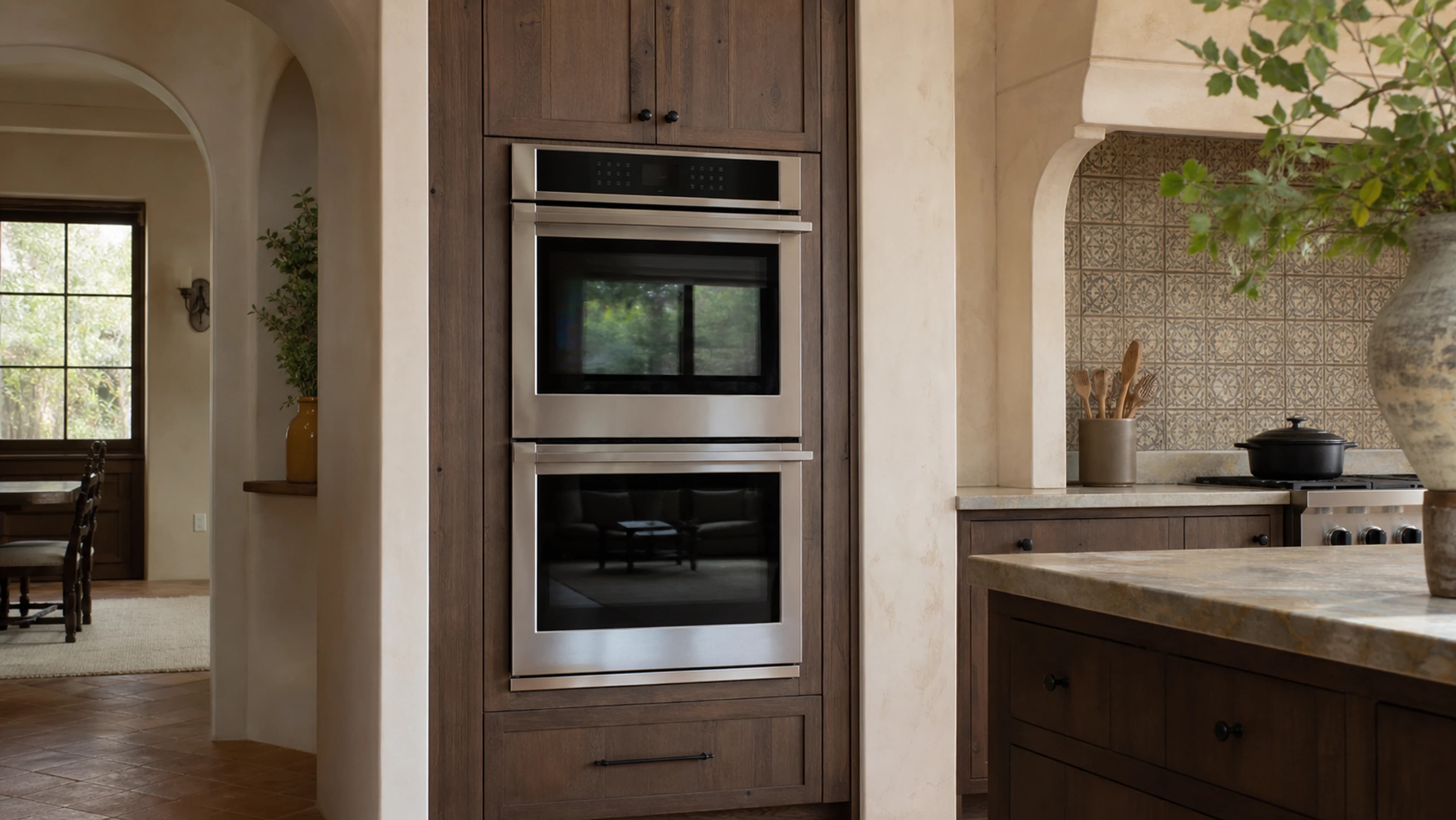 Kitchen with built-in double ovens and a range
