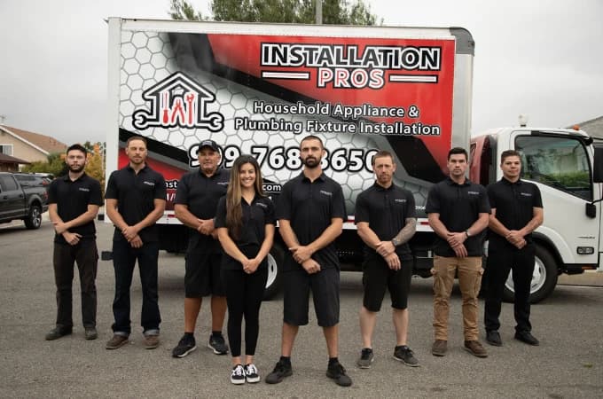 The Installation Pros team standing in front of a company truck