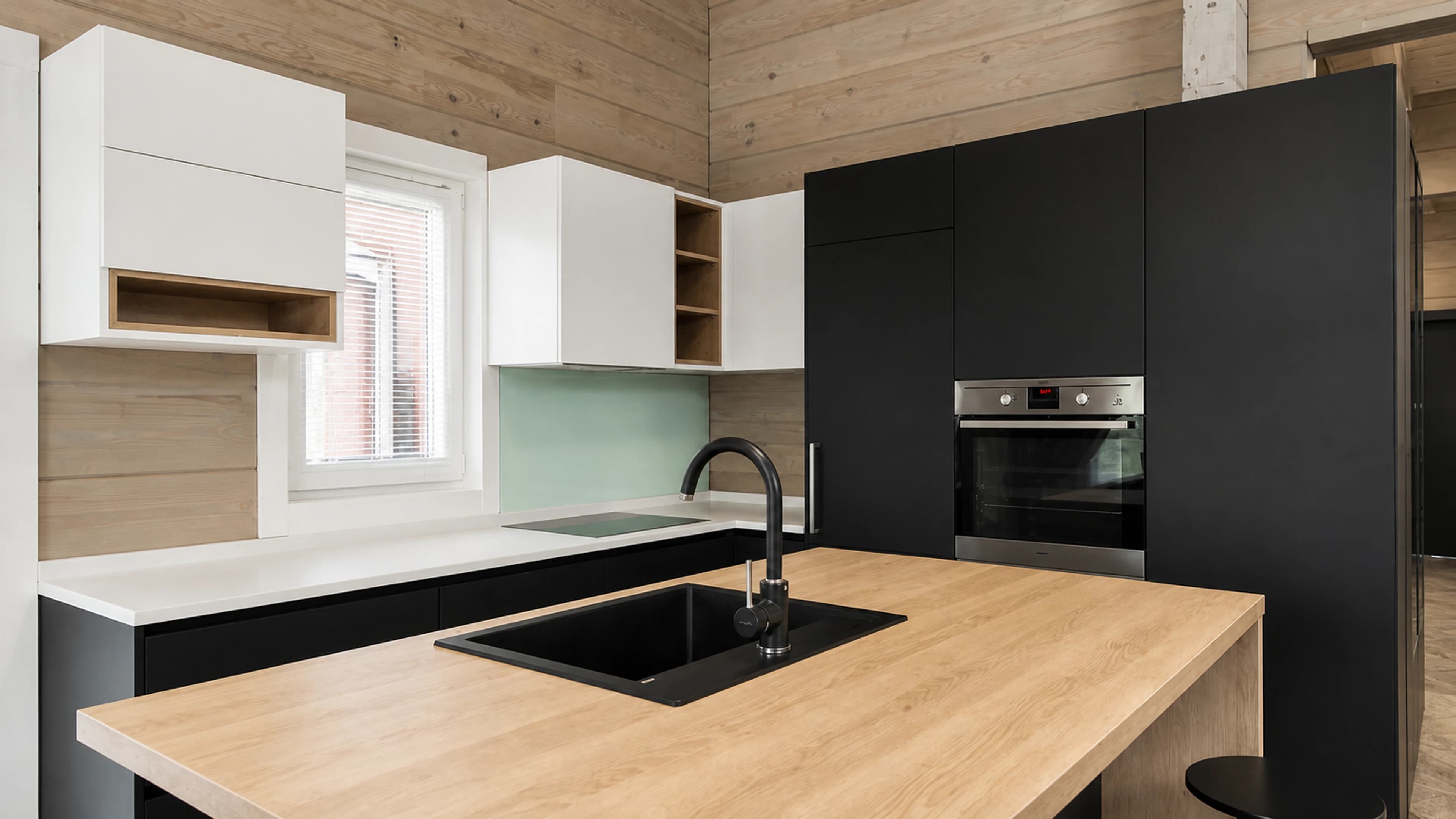Built-in trash compactor aligned with finished cabinetry