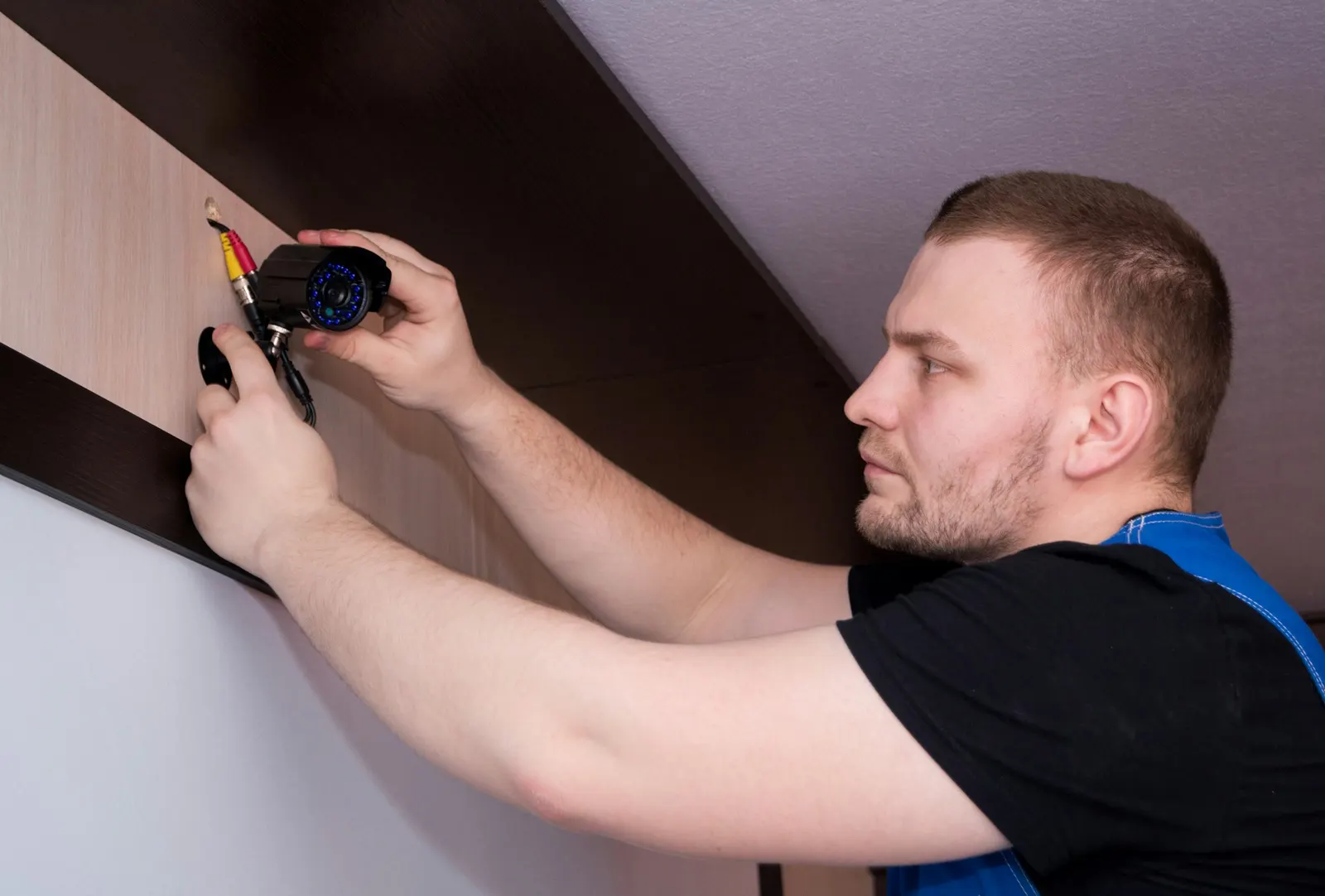Technician mounting a device on a wall
